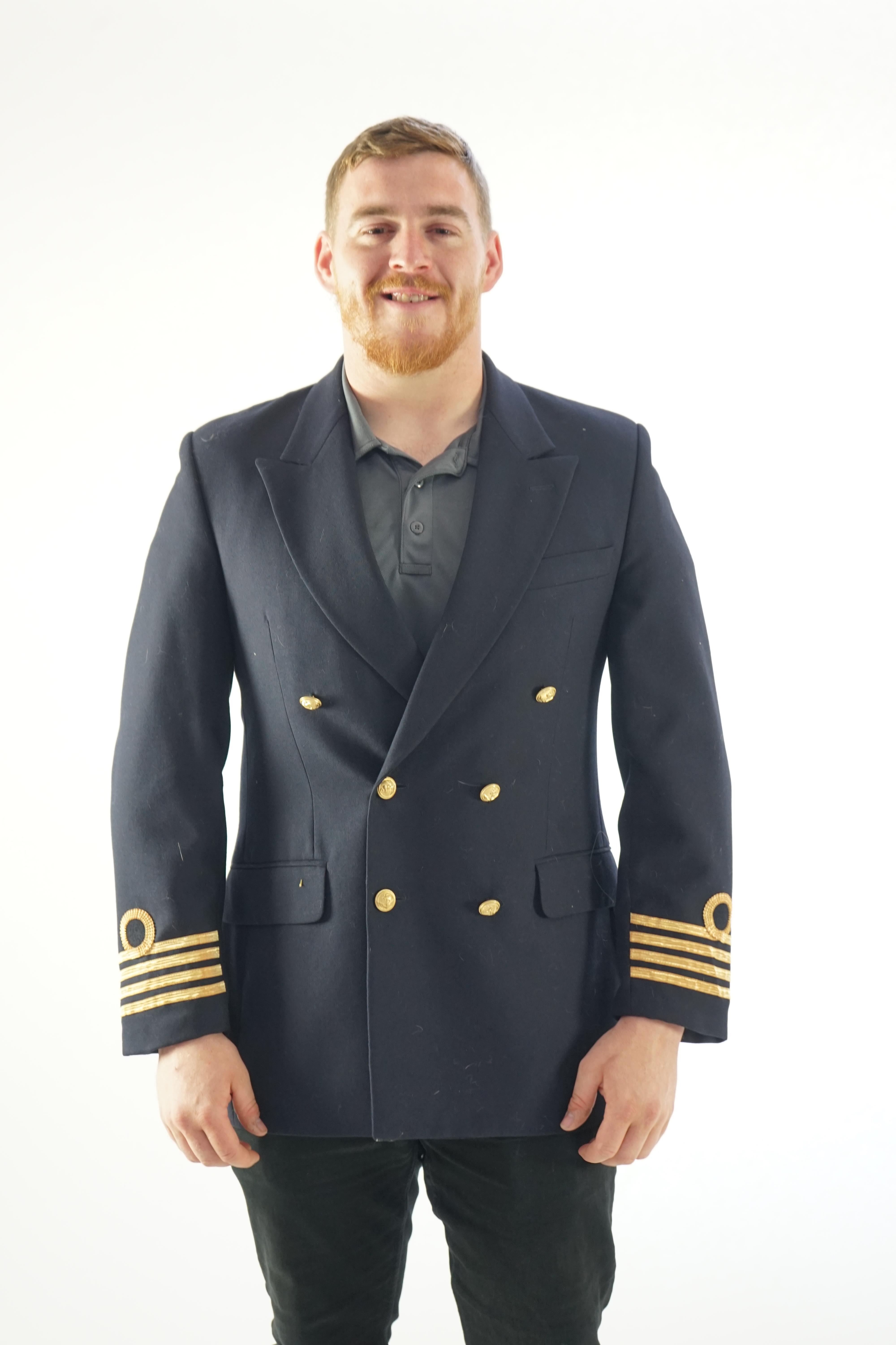 A modern naval style black-navy uniform jacket with gold trim.